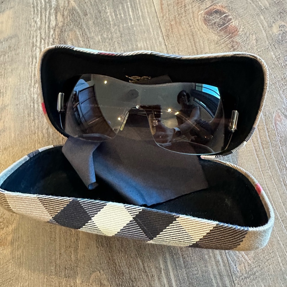 Burberry Sunglasses with Burberry plaid side pieces.